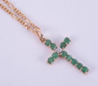 A 9ct yellow gold 18" figaro style chain with a 9ct yellow gold emerald & diamond set cross, 4.