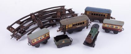 Tinplate O gauge and clockwork part train set and track.