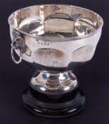 A George V silver bowl on wood plinth, with lion mask ring handles, diameter 21cm, overall height
