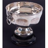 A George V silver bowl on wood plinth, with lion mask ring handles, diameter 21cm, overall height