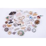 A mixed bag of costume jewellery to include earrings, bead necklaces, brooches, watch, etc.