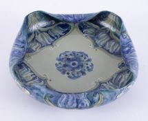 William Moorcroft, a Florian ware fold over dish, circa 1902 made for Liberty, diameter 22cm.