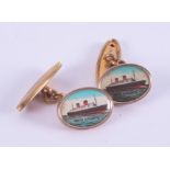 A pair of gold tone cufflinks with a picture of the Queen Victoria steamship.