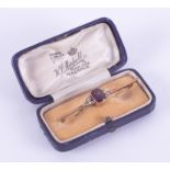 An antique 9ct yellow bar brooch with amethyst and seed pearls, boxed.