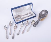 A collection of silver wares including spoons, hand mirror etc.