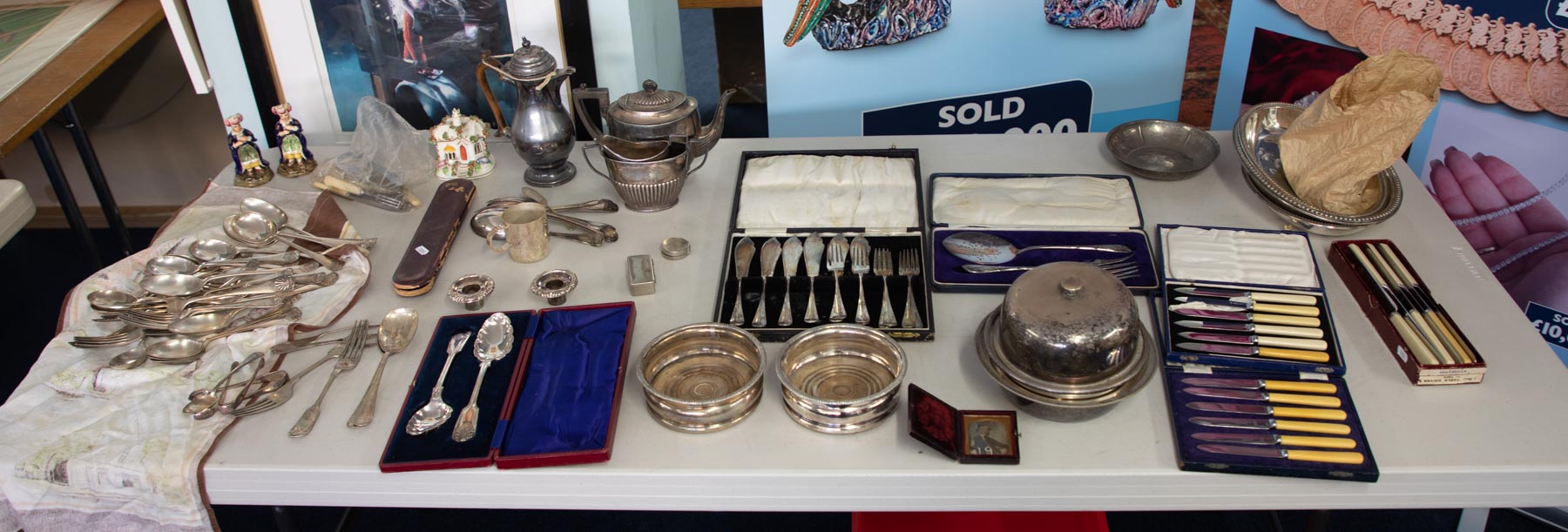 A large collection of silver plated wares including teapot, coffee pot, flatware etc.