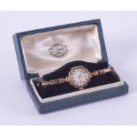 A 9ct yellow gold? Russells Ltd ladies wristwatch with a stretch bracelet marked on 9ct on metal, in