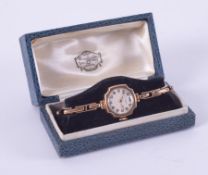 A 9ct yellow gold? Russells Ltd ladies wristwatch with a stretch bracelet marked on 9ct on metal, in