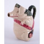 A 19th Century jug in the form of a pig with red sash, height 21cm.