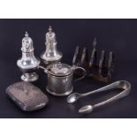 Various silver objects including a four division toast rack, embossed and engraved cigarette case,