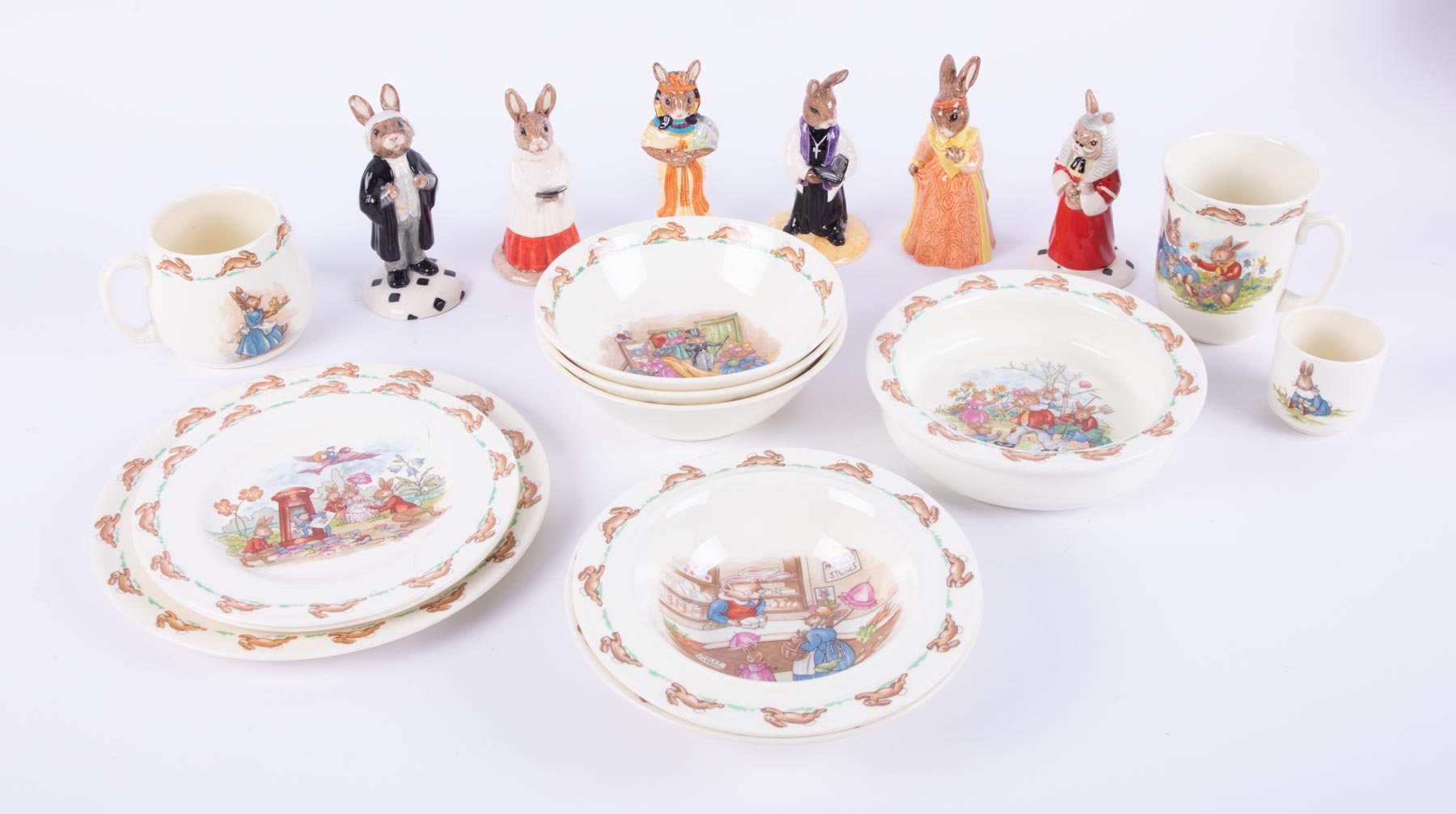 A collection of Bunnykins including 'Lawyer Bunnykins', 'Choir Singer' etc also cups, plates, bowls.