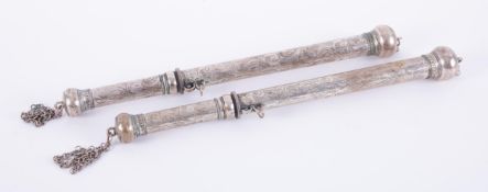 A pair of middle Eastern white metal rods with chains, length 35cm.