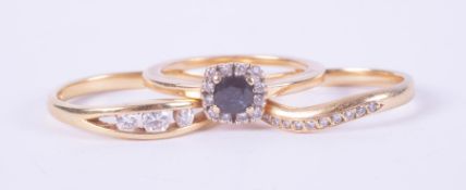 Three 18ct yellow gold rings to include a cluster style ring set with a sapphire, approx. 0.25