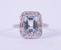 A fine 18ct white gold Art Deco style ring set with a central emerald cut Aquamarine,