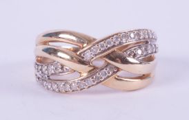 A 9ct yellow gold crossover design ring set with small round brilliant cut diamonds, total weight