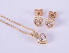 A matching set of jewellery to include an 18ct yellow gold heart shaped pendant set with three round