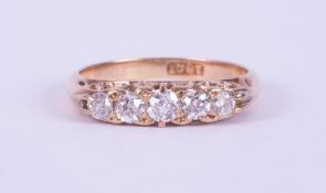 An antique 18ct yellow gold five stone ring set with five old round cut diamonds, total