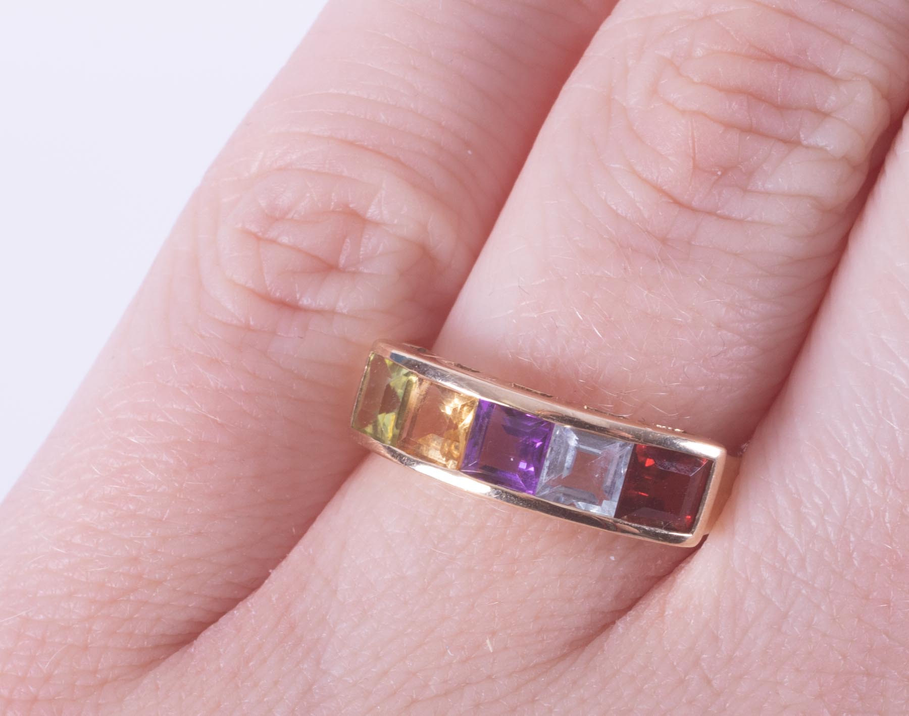 A 9ct yellow gold multi-stone ring set with a square cut garnet, blue topaz, amethyst, citrine & - Image 2 of 2