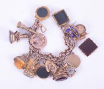 A 9ct rose gold double albert chain charm bracelet with fifteen charm attached mostly