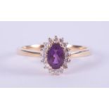 An 18ct yellow gold cluster style ring set with a central oval cut amethyst, approx. 0.43 carats,