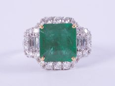 An impressive 18ct white & yellow gold ring set centrally with a square cut emerald, approx. 4.95