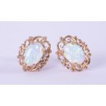A pair of 9ct yellow gold filigree style stud earrings set with cabochon cut white opal, each opal