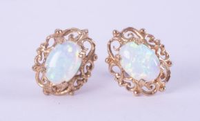 A pair of 9ct yellow gold filigree style stud earrings set with cabochon cut white opal, each opal