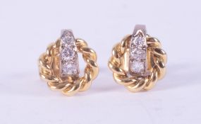 A pair of 18ct yellow & white gold twisted rope design round earrings each set with three