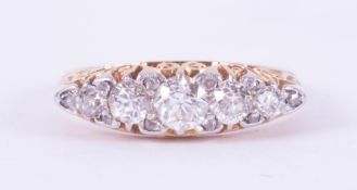 An antique 18ct yellow gold & platinum scroll design ring set with five old round cut diamonds,