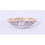 An 18ct yellow gold & platinum ring set with a central round brilliant cut diamond, approx. 0.36