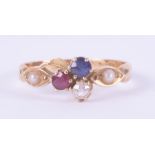 An antique 18ct yellow gold ring set centrally with a round cut ruby, sapphire & diamond with a