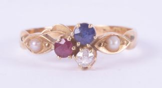 An antique 18ct yellow gold ring set centrally with a round cut ruby, sapphire & diamond with a