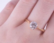 An 18ct yellow & white gold six claw solitaire ring set with a round brilliant cut diamond,