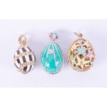 Three silver & silver gilt 'Faberge style' enamel egg pendants set with crystals, the star patterned