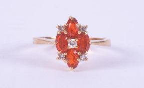 An 18ct yellow gold marquise shaped cluster style ring set with four oval cut fire opals, total