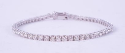 An 18ct white gold line bracelet set with approx. 5.10 carats of round brilliant cut diamonds,