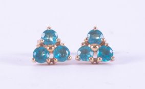 A pair of 9ct yellow gold triangular shaped stud earrings set round cut blue apatite, total weight