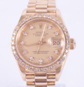 Rolex, a ladies 18ct yellow gold Rolex Oyster Perpetual Datejust with diamond set bezel and