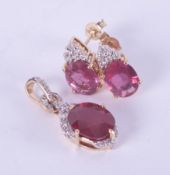 A 9ct yellow gold pendant set with an oval cut created ruby, approx. 2.83 carats set with small