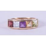 A 9ct yellow gold multi-stone ring set with a square cut garnet, blue topaz, amethyst, citrine &