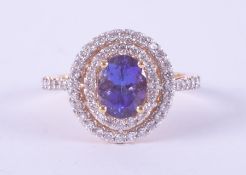 An 18ct yellow gold halo design ring set with an oval cut tanzanite, approx. 1.35 carats, surrounded