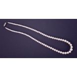 A graduated string of cultured pearls with a platinum clasp set with three round cut diamonds, total