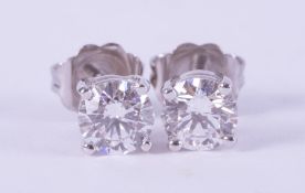 A pair of 14ct white gold stud earrings set with round brilliant cut diamonds, total weight 0.82