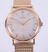 Omega, a gentleman's Omega manual wind wristwatch, gold plated case, linen baton dial, stretch