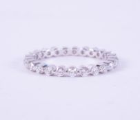 A 14ct white gold full eternity ring set with 0.90 carats of round brilliant cut diamonds,