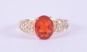 An 18ct yellow gold ring set with an oval cut fire opal, approx. 1.54 carats, with small round