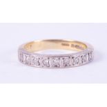 An 18ct yellow gold & platinum half eternity ring set with nine small round diamonds, total