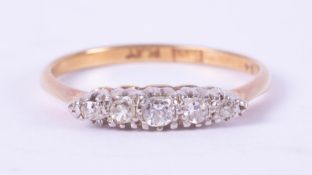 An 18ct yellow gold & platinum five stone diamond ring, set with approx. 0.15 carats total weight of
