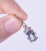 A 9ct white gold pendant set with an oval cut aquamarine, approx. 3.09 carats, with three