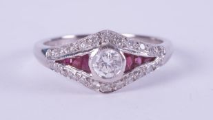 An 18ct white gold Art Deco style ring set with a central rubover set round brilliant cut diamond,